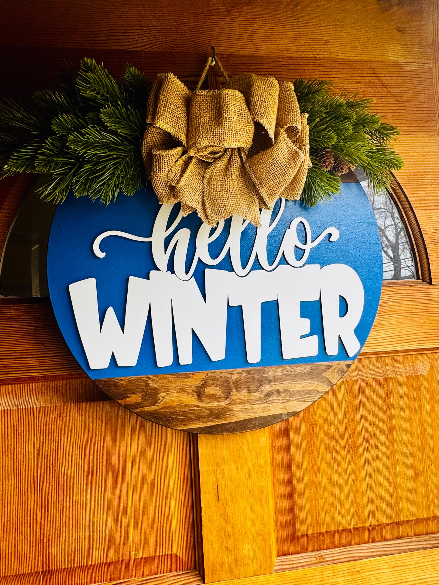 Hello Winter Door Hanger – 18” Round | Extra Thick 1” Wooden Winter Sign | Burlap Bow & Pine Décor